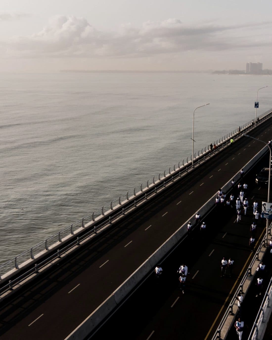 Road bridge crossing open water at Dar es Salaam in morning haze.